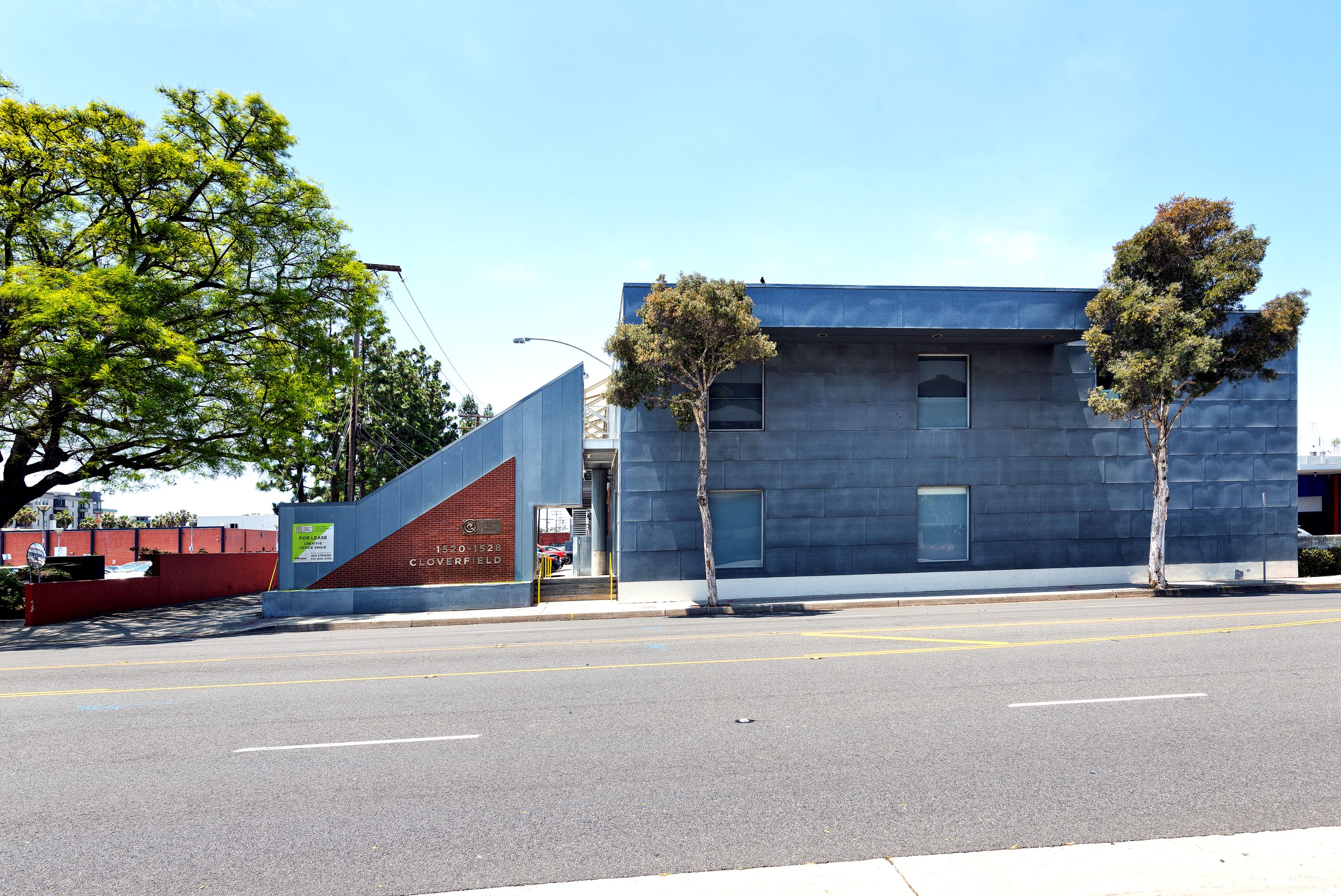 1520 Cloverfield side elevation — stainless-steel fascia over brick